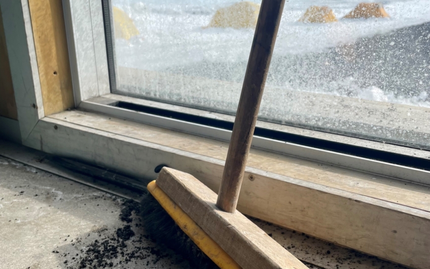 Broom and detached fragile label at West Beach camp container hut Cape Evans Photo Deborah Diaz