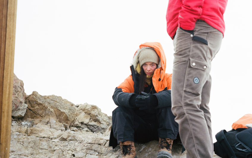 Lorde sitting down in antarctica